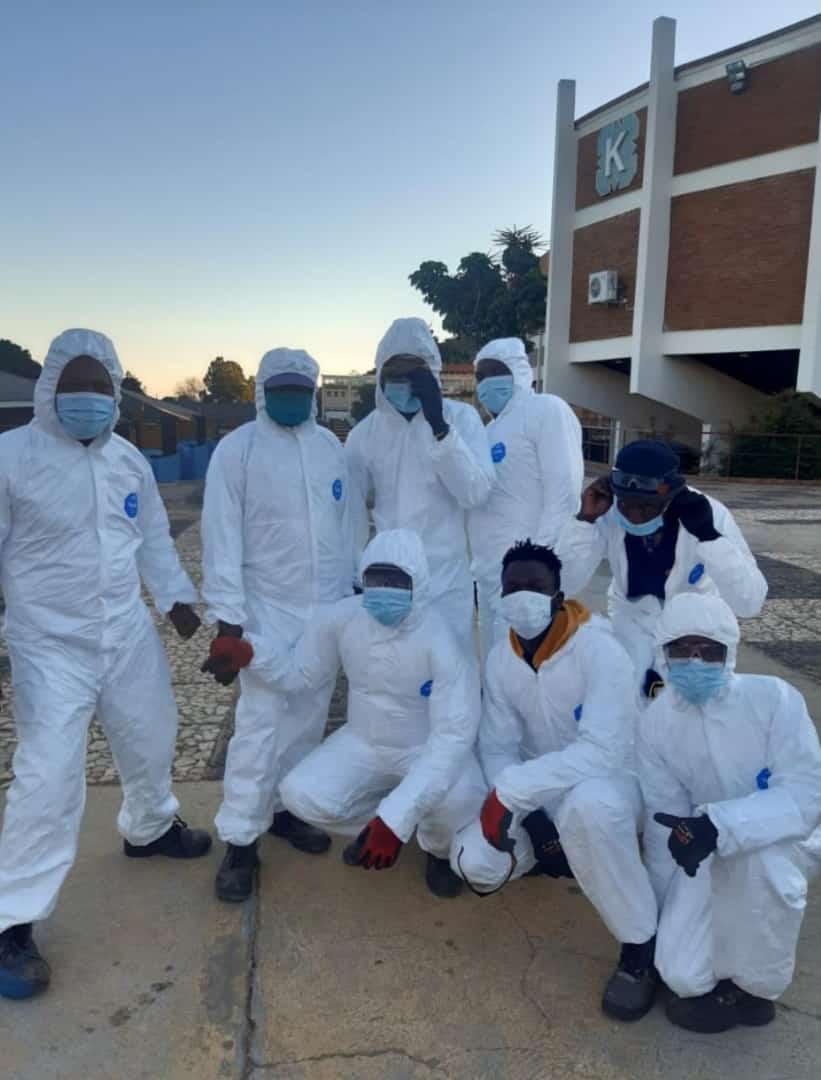 Abatement crew in protective coveralls before entry