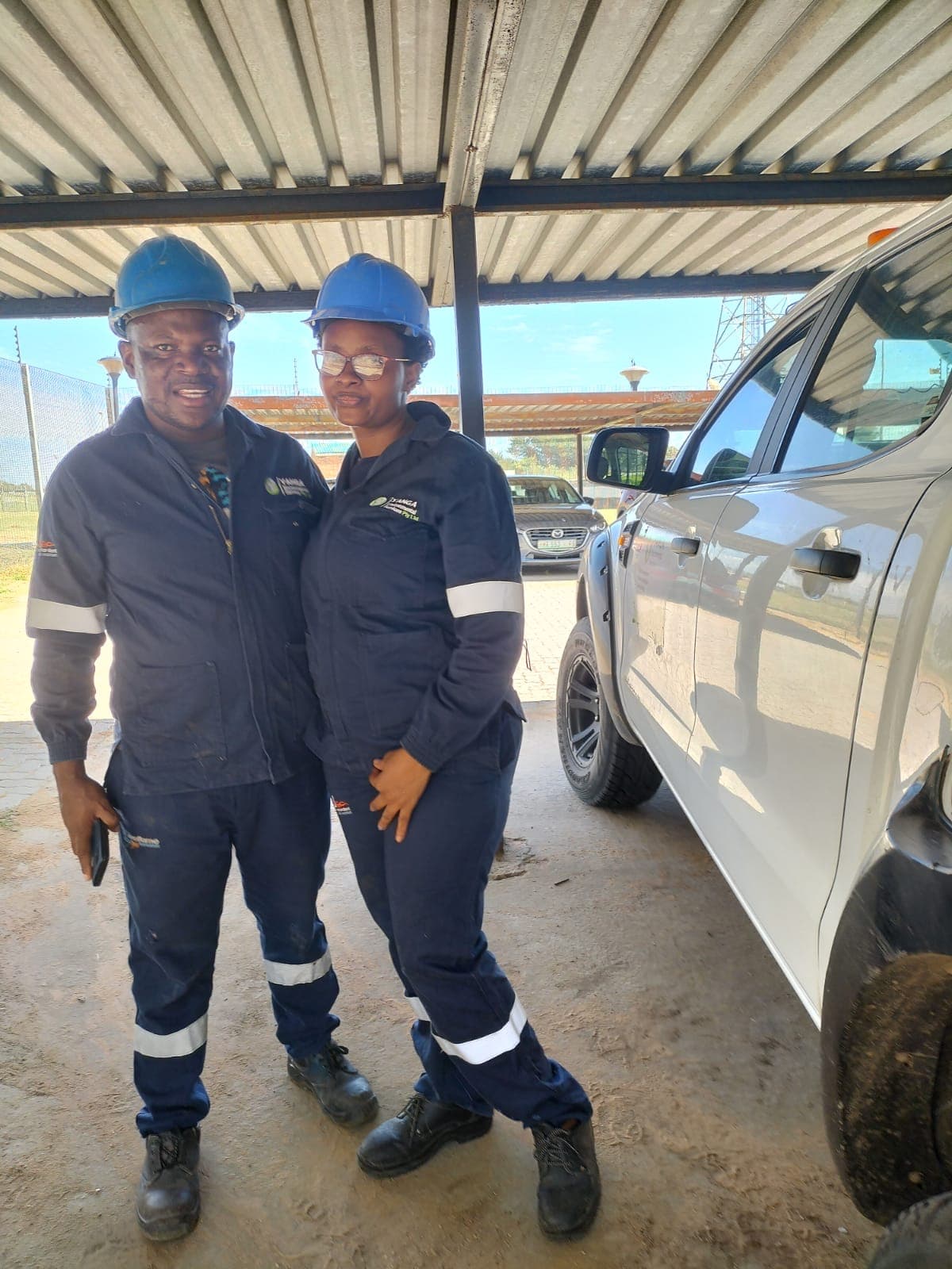 Yanga staff in branded protective clothing on site