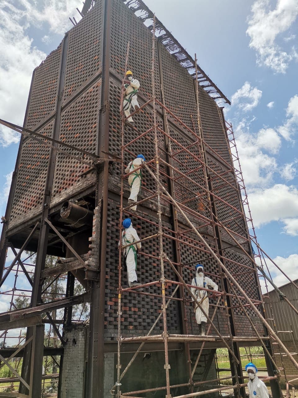 Yanga crews removing asbestos cladding from an industrial cooling tower